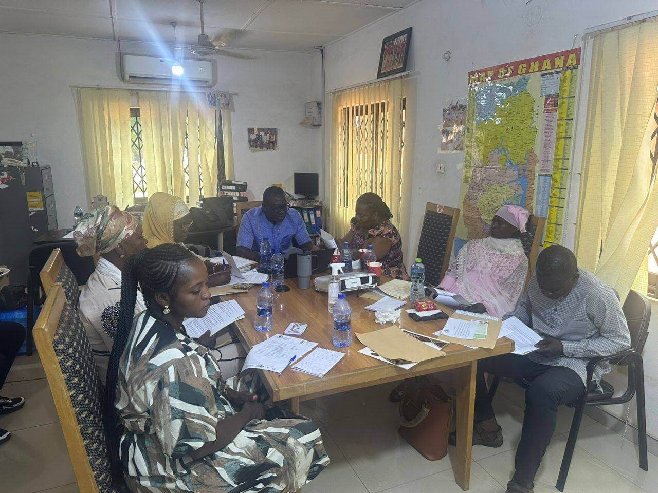 Board members and staff meeting around a table in the Development Frontiers office