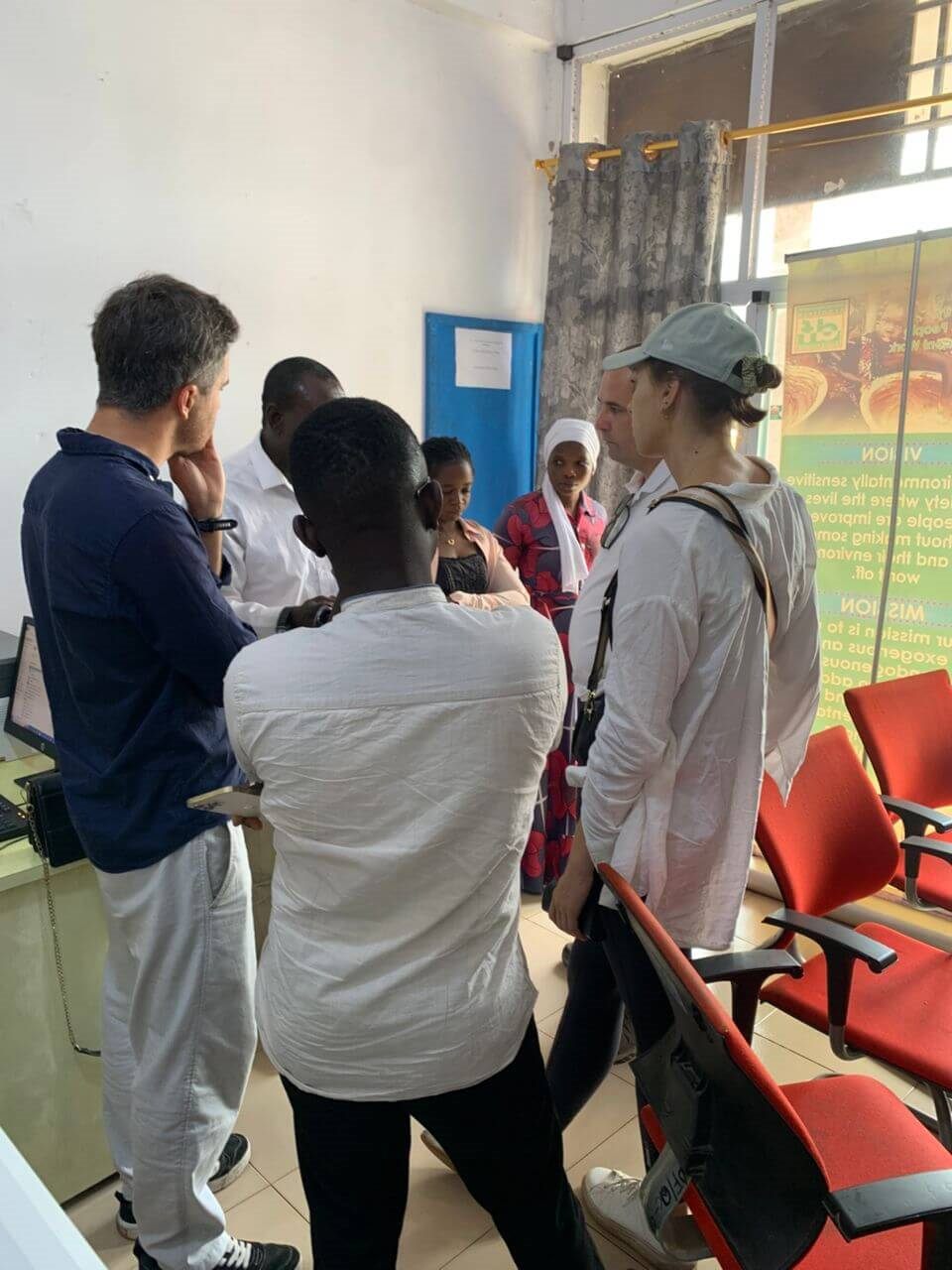 Staff and international visitors discussing programme work at the DF office