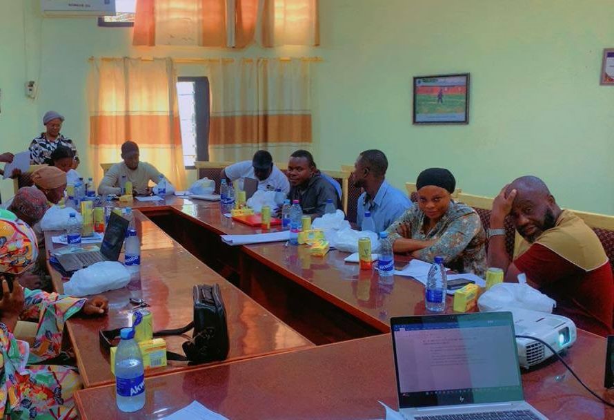Participants seated around a large U-shaped table during a stakeholder workshop